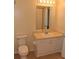 Bright bathroom with a white vanity, mirror, and toilet at 18001 Richmond Place Dr # 636, Tampa, FL 33647