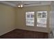 Bedroom with fan and carpet, featuring a view of the building next door through two windows at 18001 Richmond Place Dr # 636, Tampa, FL 33647