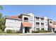 Exterior view of a condo building featuring stairs, balconies, and well-maintained landscaping at 18001 Richmond Place Dr # 636, Tampa, FL 33647