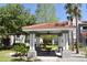 Community gazebo with picnic table, ceiling fan and lush landscaping, with condo buildings in background at 18001 Richmond Place Dr # 636, Tampa, FL 33647