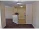 Carpeted living room view into kitchen with breakfast bar and standard appliances at 18001 Richmond Place Dr # 636, Tampa, FL 33647