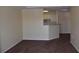Cozy living room with plush brown carpet and neutral walls adjacent to kitchen at 18001 Richmond Place Dr # 636, Tampa, FL 33647