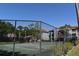 View of a community tennis court with manicured surroundings and residential buildings in the background at 18001 Richmond Place Dr # 636, Tampa, FL 33647