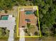 Aerial perspective of the property showcasing its layout with the pool, shed, and landscape at 21080 Firwood Ter, Port Charlotte, FL 33954