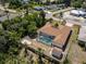 An aerial shot of the property featuring a screened-in pool and a backyard fire pit at 21080 Firwood Ter, Port Charlotte, FL 33954