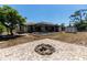 A backyard featuring a screened pool, storage shed, and a charming brick fire pit area at 21080 Firwood Ter, Port Charlotte, FL 33954