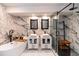 Luxurious bathroom with dual vanities, marble accents, freestanding tub, and a glass shower at 21080 Firwood Ter, Port Charlotte, FL 33954