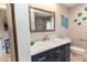 Bathroom featuring a vanity with marble countertop, framed mirror, and marine themed decorations at 21080 Firwood Ter, Port Charlotte, FL 33954