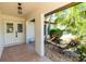 Charming entryway with double doors, decorative stone, and landscaped garden at 21080 Firwood Ter, Port Charlotte, FL 33954