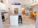 Bright, modern kitchen with large island, stainless appliances and wood-look floors at 21080 Firwood Ter, Port Charlotte, FL 33954