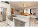 Stylish eat-in kitchen with stainless appliances, center island, and wood dining table at 21080 Firwood Ter, Port Charlotte, FL 33954