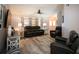Comfortable living room with leather furniture, wood-look floors, and natural light at 21080 Firwood Ter, Port Charlotte, FL 33954