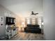 Comfortable living room with modern decor, ceiling fan and ample natural light at 21080 Firwood Ter, Port Charlotte, FL 33954