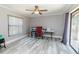 Home office filled with natural light, ceiling fan, and new flooring at 21080 Firwood Ter, Port Charlotte, FL 33954