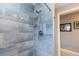 Shower showcasing blue tiles with a hand-held shower head and a corner shelf at 21080 Firwood Ter, Port Charlotte, FL 33954