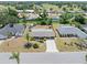 Aerial view of a single-story home featuring a large yard, mature trees and a concrete driveway at 218 Parkview Dr, Venice, FL 34293