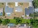 Aerial view showcases the backyard of a home in a quiet neighborhood with mature trees at 218 Parkview Dr, Venice, FL 34293