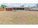View of the spacious backyard featuring a screened-in porch, grill and partial fencing at 218 Parkview Dr, Venice, FL 34293