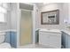 Bathroom with a shower, updated vanity, mirror, and charming wall accents at 218 Parkview Dr, Venice, FL 34293