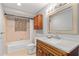 Bathroom featuring neutral tan walls, a tub and shower combo and modern granite-look vanity at 218 Parkview Dr, Venice, FL 34293
