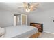 Bedroom with gray walls, wood-look flooring, modern dresser, and unique sliding barn door at 218 Parkview Dr, Venice, FL 34293