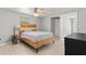 Comfortable bedroom with neutral paint, wood accent bed frame, and a ceiling fan at 218 Parkview Dr, Venice, FL 34293