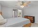 Bright bedroom featuring a ceiling fan, modern dresser, light gray walls, and wood-look plank flooring at 218 Parkview Dr, Venice, FL 34293