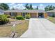 Charming single-story home featuring a well-manicured front yard and extended driveway at 218 Parkview Dr, Venice, FL 34293