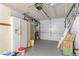 Spacious two car garage featuring a full-size refrigerator and shelving for extra storage at 218 Parkview Dr, Venice, FL 34293