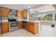 Updated kitchen with stainless steel appliances and a breakfast bar overlooking the dining area at 218 Parkview Dr, Venice, FL 34293