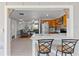 Open-concept kitchen with bar seating, stainless steel appliances, and easy access to the living area at 218 Parkview Dr, Venice, FL 34293
