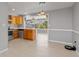 Bright kitchen with wood cabinets, stainless appliances, and an open layout to a sunroom at 218 Parkview Dr, Venice, FL 34293