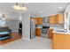 Well-lit kitchen featuring stainless steel appliances, wood cabinets, and tiled backsplash at 218 Parkview Dr, Venice, FL 34293