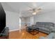 Inviting living room featuring hardwood floors, ceiling fan, and comfortable gray sofa set at 218 Parkview Dr, Venice, FL 34293