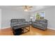 Open living room with gray sofa set, hardwood floors, and bright natural light at 218 Parkview Dr, Venice, FL 34293