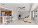 Open sunroom with bar seating area, neutral walls and floors, with easy access to kitchen at 218 Parkview Dr, Venice, FL 34293