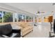 Bright and spacious sunroom with large windows offering views of the fenced backyard and landscaping at 218 Parkview Dr, Venice, FL 34293