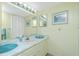 Bright bathroom with a large mirror, single vanity sink, and neutral decor at 22375 Edgewater Dr # 128, Port Charlotte, FL 33980