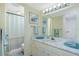 Bathroom featuring single sink vanity, large mirror, and shower with curtain at 22375 Edgewater Dr # 128, Port Charlotte, FL 33980