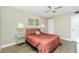 Bedroom featuring a double bed with red floral bedding and two side tables at 22375 Edgewater Dr # 128, Port Charlotte, FL 33980
