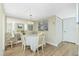 Elegant dining room with mirrored wall, chandelier, and a table set for a delightful meal at 22375 Edgewater Dr # 128, Port Charlotte, FL 33980