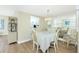 Elegant dining room next to the kitchen area, with mirrored wall, chandelier, and set table at 22375 Edgewater Dr # 128, Port Charlotte, FL 33980