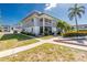 Attractive condo building with screened balconies, complemented by lush tropical landscaping and mature palm trees at 22375 Edgewater Dr # 128, Port Charlotte, FL 33980