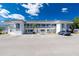 Well-maintained condo building with white facade, balconies, and ample parking under a blue sky at 22375 Edgewater Dr # 128, Port Charlotte, FL 33980