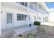 Close-up view of a condo exterior with clean white facade and neatly arranged landscaping at 22375 Edgewater Dr # 128, Port Charlotte, FL 33980