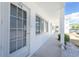 Well-maintained condo exterior showcasing a bright white facade with ample natural light and landscaping at 22375 Edgewater Dr # 128, Port Charlotte, FL 33980