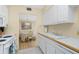 Clean and functional kitchen flowing into the dining area, with white cabinets and ample counter space at 22375 Edgewater Dr # 128, Port Charlotte, FL 33980