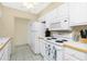 Bright white kitchen with modern appliances, clean countertops, and ample cabinet space at 22375 Edgewater Dr # 128, Port Charlotte, FL 33980