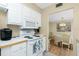 Cozy kitchen with white appliances, cabinets, and a view into the elegant dining space at 22375 Edgewater Dr # 128, Port Charlotte, FL 33980