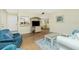 Cozy living room featuring wood floors, comfortable seating, and a view into the adjacent dining area at 22375 Edgewater Dr # 128, Port Charlotte, FL 33980